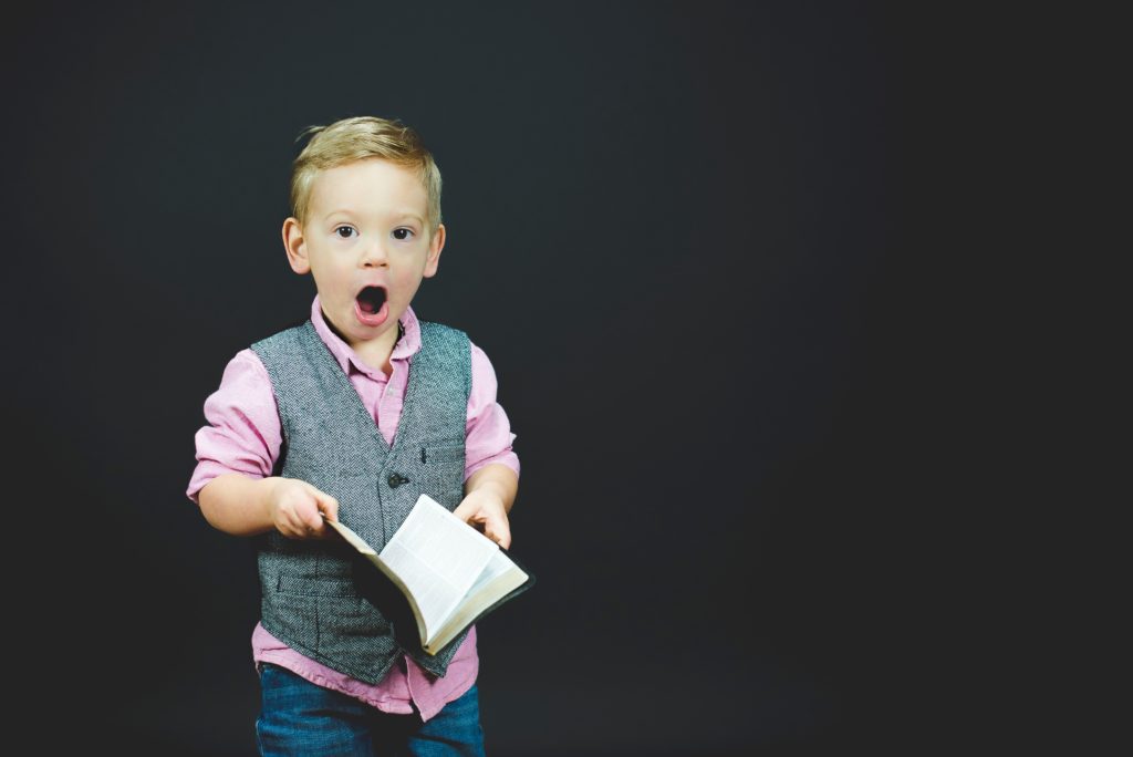 Shocked child holding a book